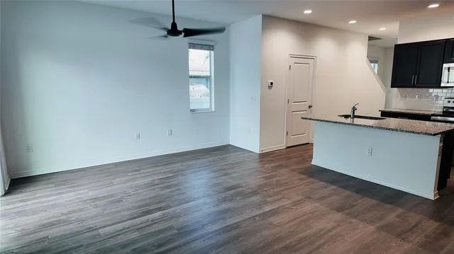 a view of a kitchen with wooden floor and a sink