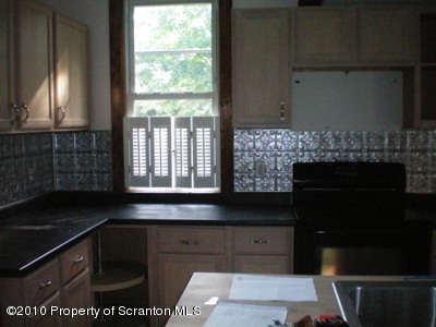 100 James Street Shavertown, PA 18708 - Photo 4 of 14 a kitchen with granite countertop a stove a sink and a microwave
