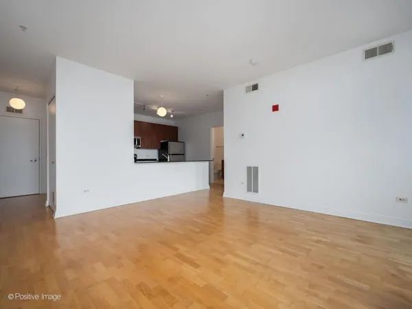 a view of a kitchen with a sink and a refrigerator