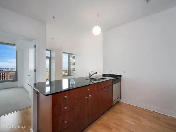 a bathroom with a granite countertop sink a mirror and vanity