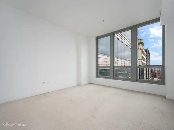 an empty room with large windows