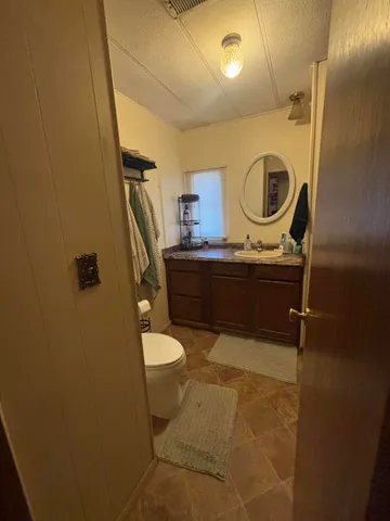 a bedroom with a bed flat screen tv and dresser