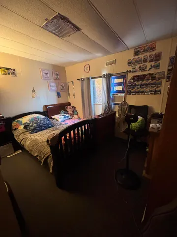 a bathroom with a granite countertop sink a mirror and shower