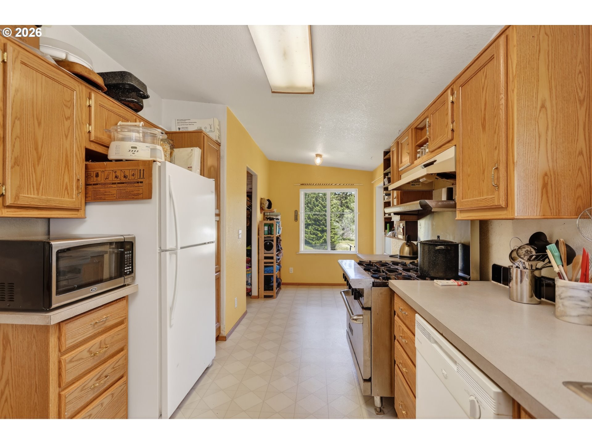 97 Kida Road White Salmon, WA 98672 - Photo 31 of 45 a kitchen with stainless steel appliances a sink a stove a refrigerator cabinets and a window