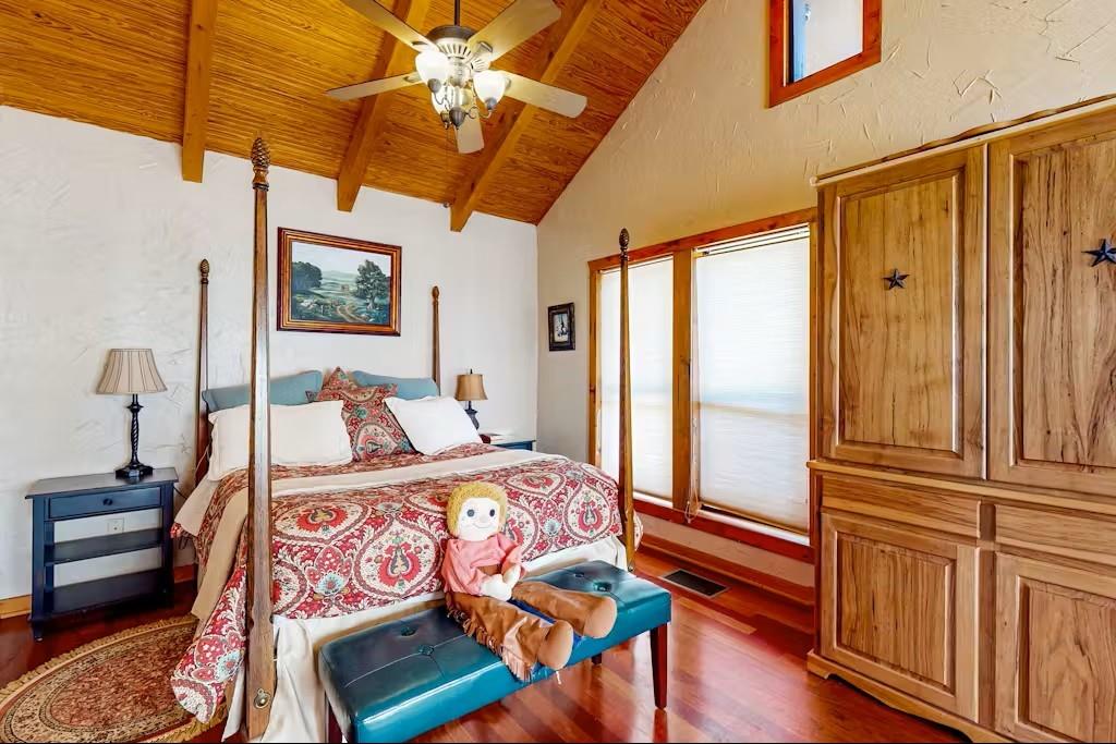 120 Live Oak Road Whitney, TX 76692 - Photo 13 of 21 a bedroom with a bed a dresser with wooden floor