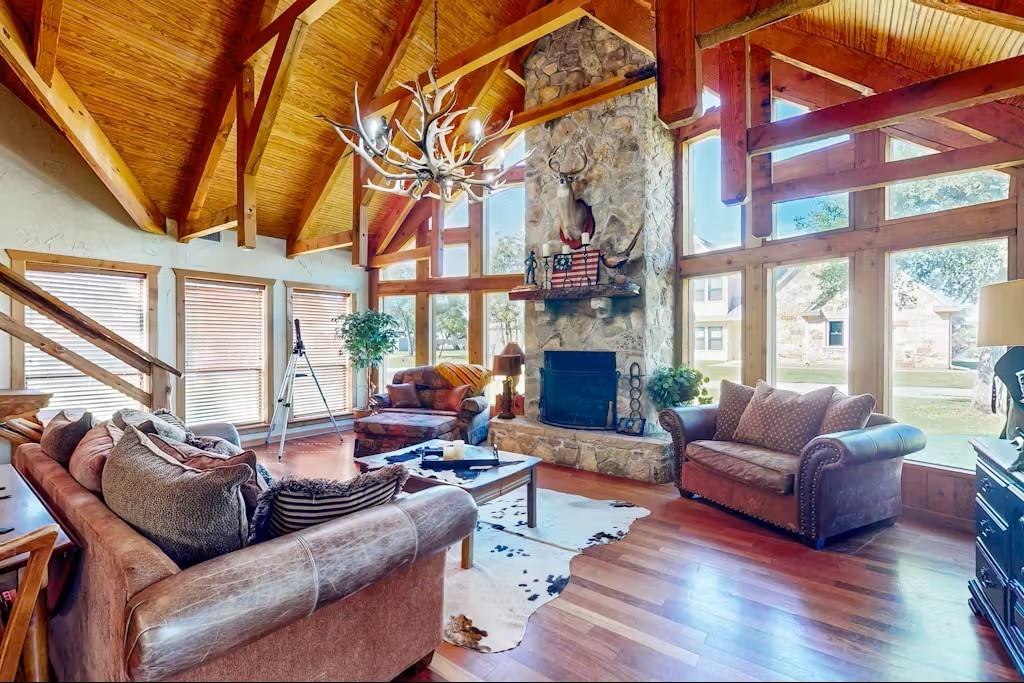 120 Live Oak Road Whitney, TX 76692 - Photo 3 of 21 a living room with furniture a large window and a fireplace