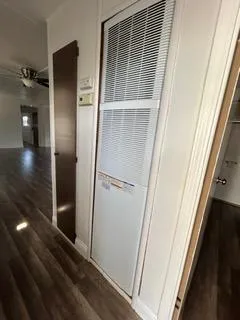 a view of an empty room with wooden floor