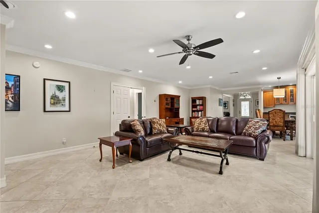 a living room with furniture and a ceiling fan
