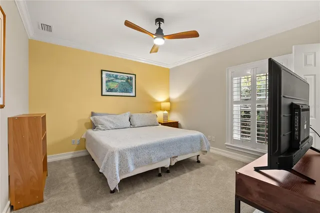 a bedroom with a bed workspace and a window