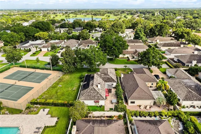 an aerial view of a house with garden space and street view