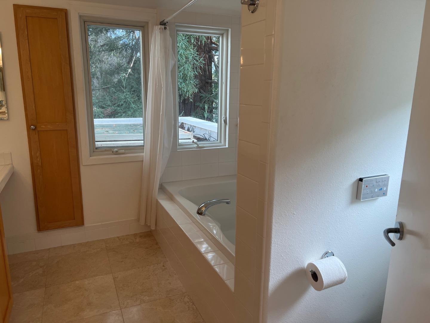2198 Avy Avenue Menlo Park, CA 94025 - Photo 16 of 39 a bathroom with a tub a window and a shower