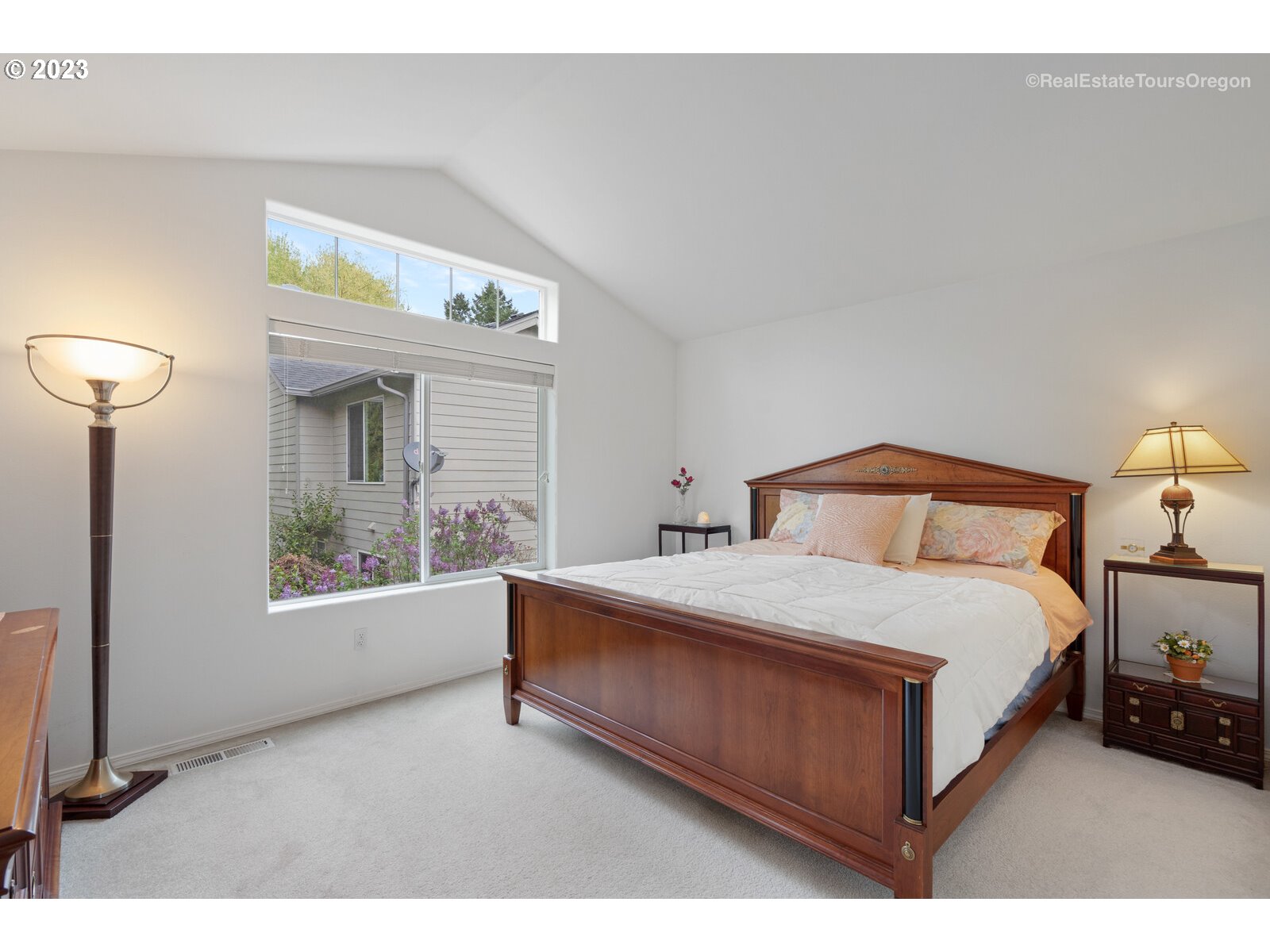 14345 Holly Springs Road Lake Oswego, OR 97035 - Photo 14 of 32 a bedroom with a bed and a large window