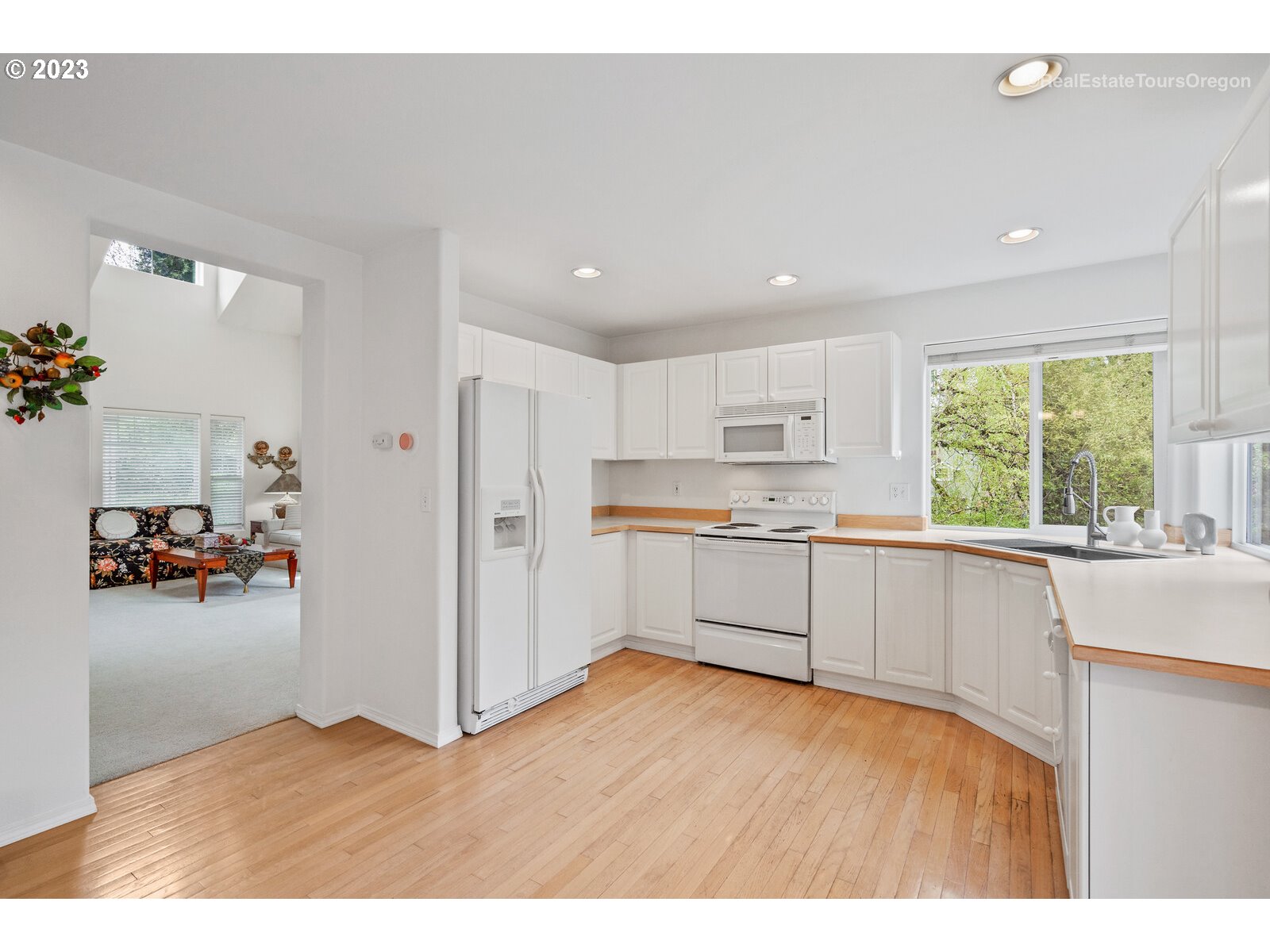 14345 Holly Springs Road Lake Oswego, OR 97035 - Photo 6 of 32 a kitchen with a refrigerator and a sink