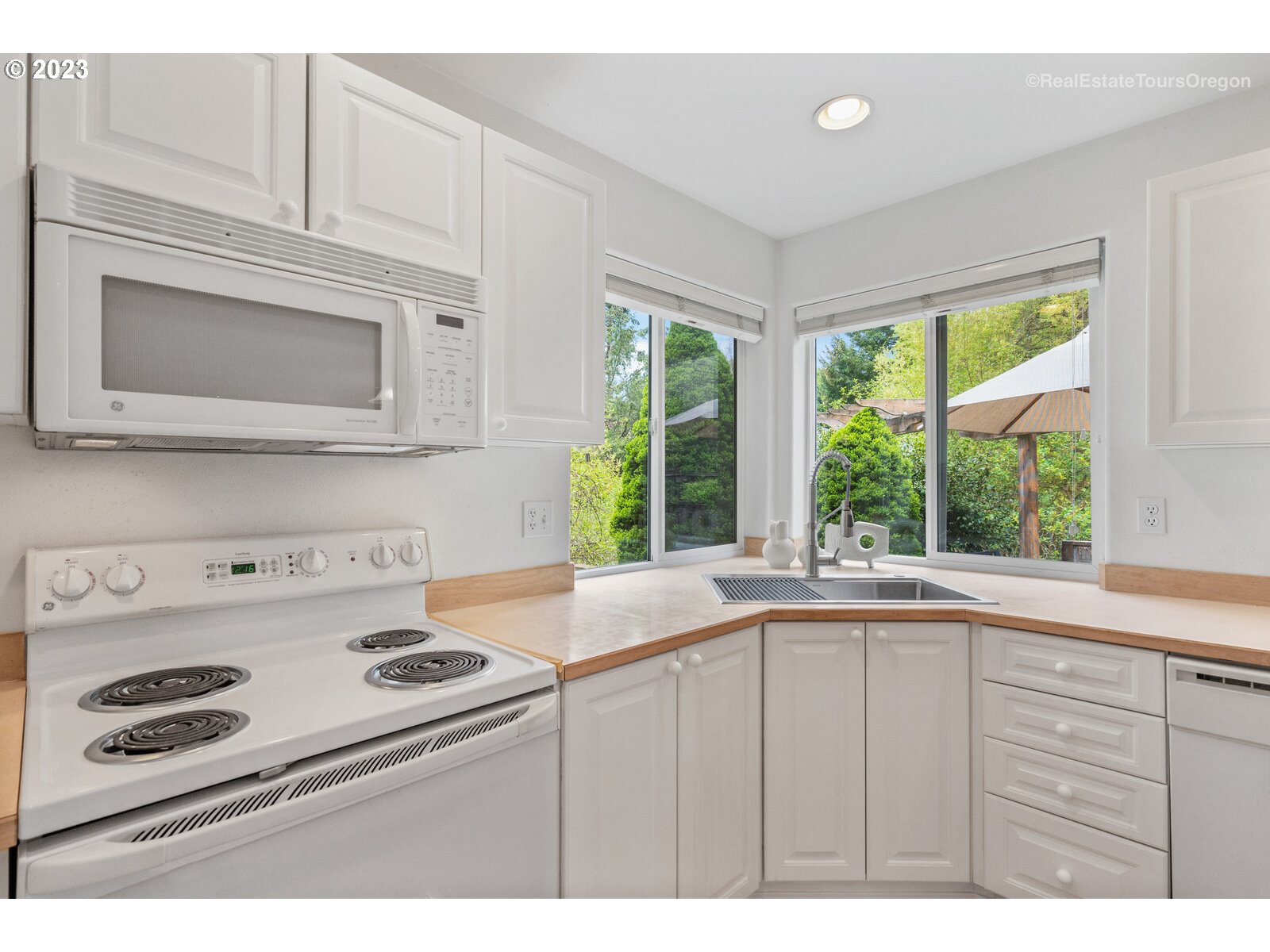 14345 Holly Springs Road Lake Oswego, OR 97035 - Photo 7 of 32 a kitchen with a stove a sink and a microwave