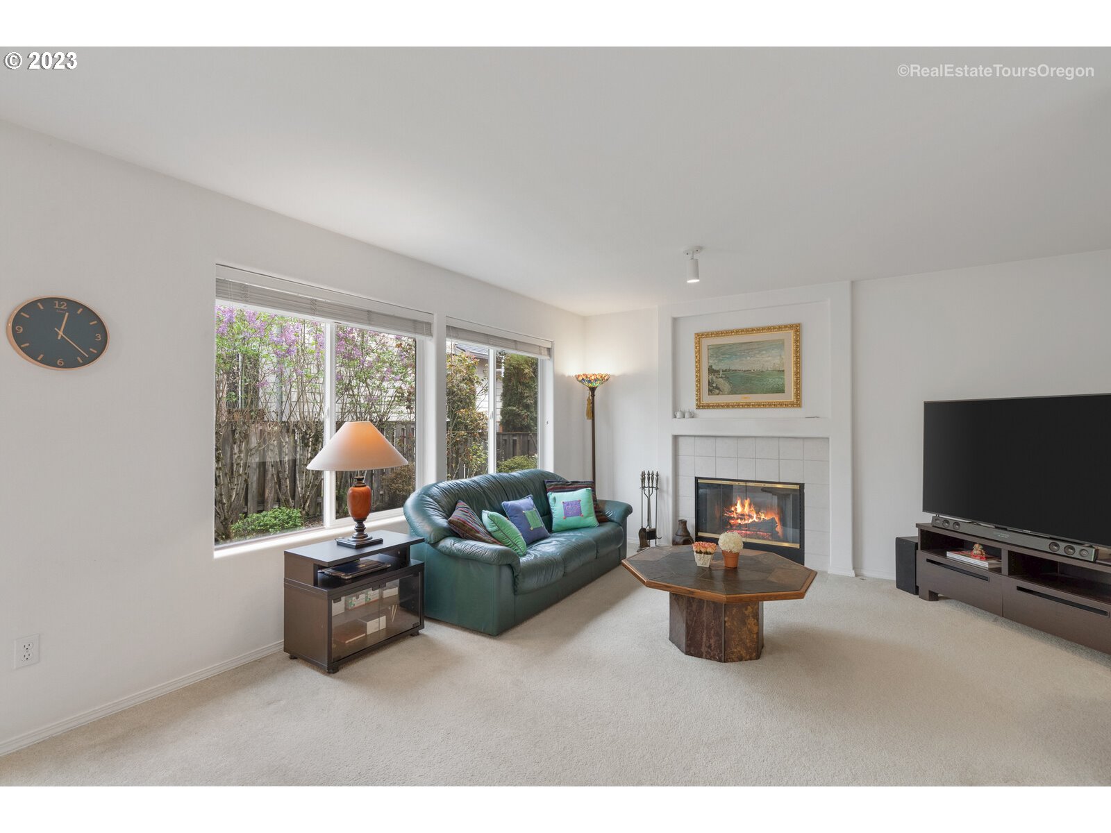14345 Holly Springs Road Lake Oswego, OR 97035 - Photo 10 of 32 a living room with furniture a flat screen tv and a fireplace