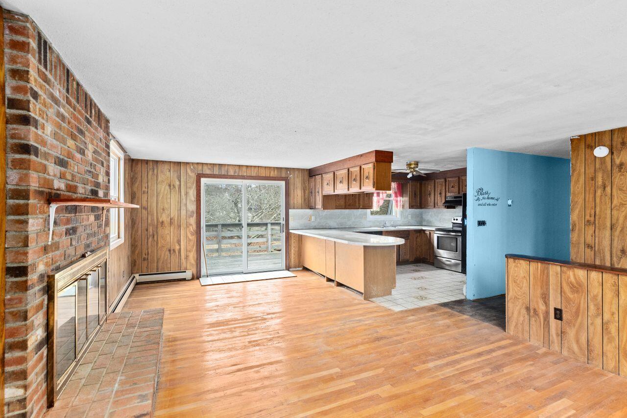 1460 Massasoit Road Eastham, MA 02642 - Photo 12 of 42 a large kitchen with stainless steel appliances kitchen island granite countertop a refrigerator and a stove top oven