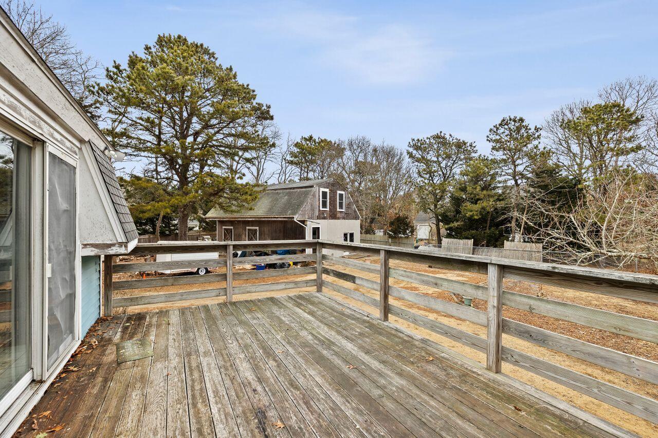 1460 Massasoit Road Eastham, MA 02642 - Photo 13 of 42 a view of roof deck with furniture and wooden floor