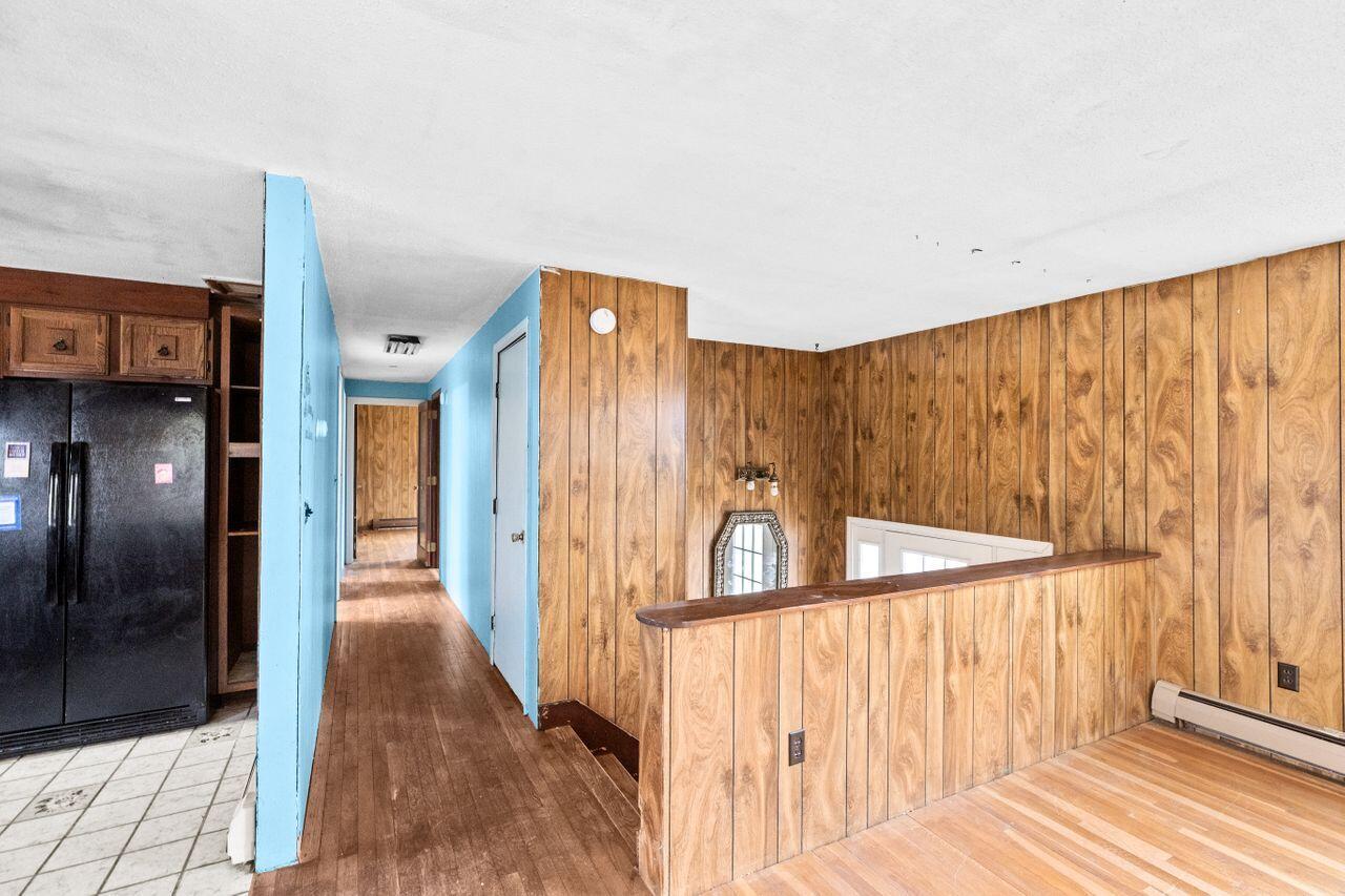 1460 Massasoit Road Eastham, MA 02642 - Photo 14 of 42 a view of a hallway with wooden floor and staircase