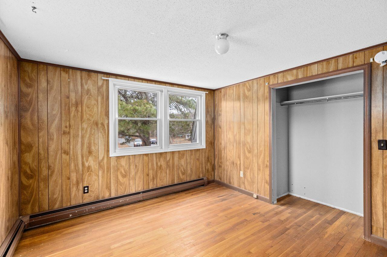 1460 Massasoit Road Eastham, MA 02642 - Photo 18 of 42 a view of an empty room with wooden floor and a window