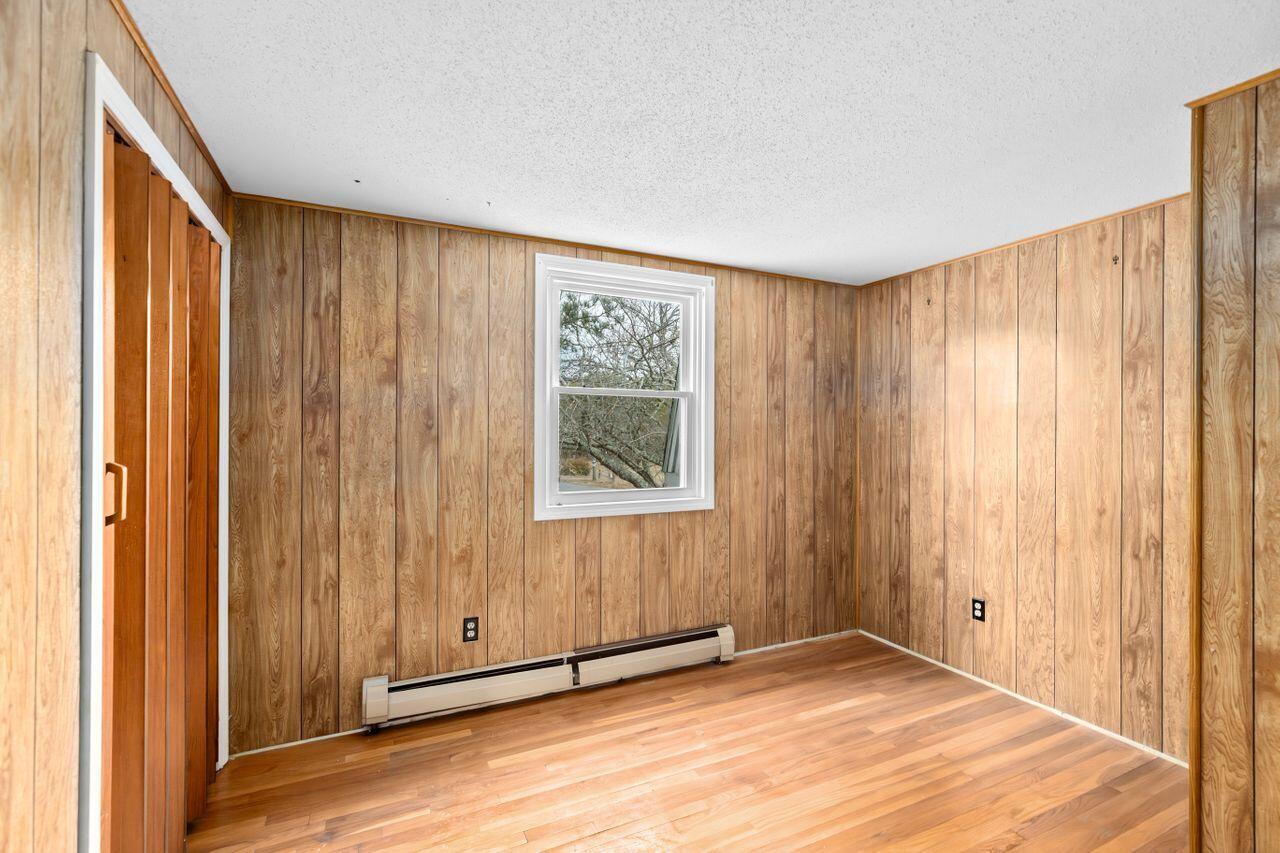 1460 Massasoit Road Eastham, MA 02642 - Photo 19 of 42 a view of an empty room with wooden floor and a window