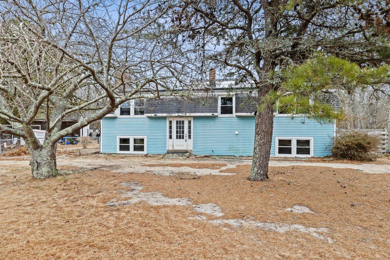 1460 Massasoit Road Eastham, MA 02642 - Photo 2 of 42 a front view of house with yard and trees