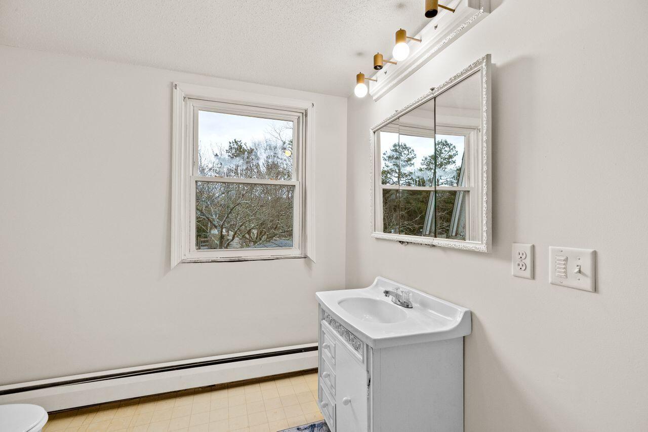 1460 Massasoit Road Eastham, MA 02642 - Photo 21 of 42 a bathroom with a sink and a window