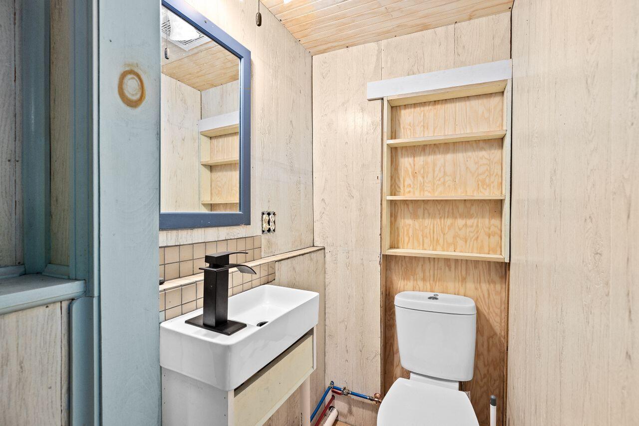 1460 Massasoit Road Eastham, MA 02642 - Photo 33 of 42 a bathroom with a toilet sink vanity and mirror