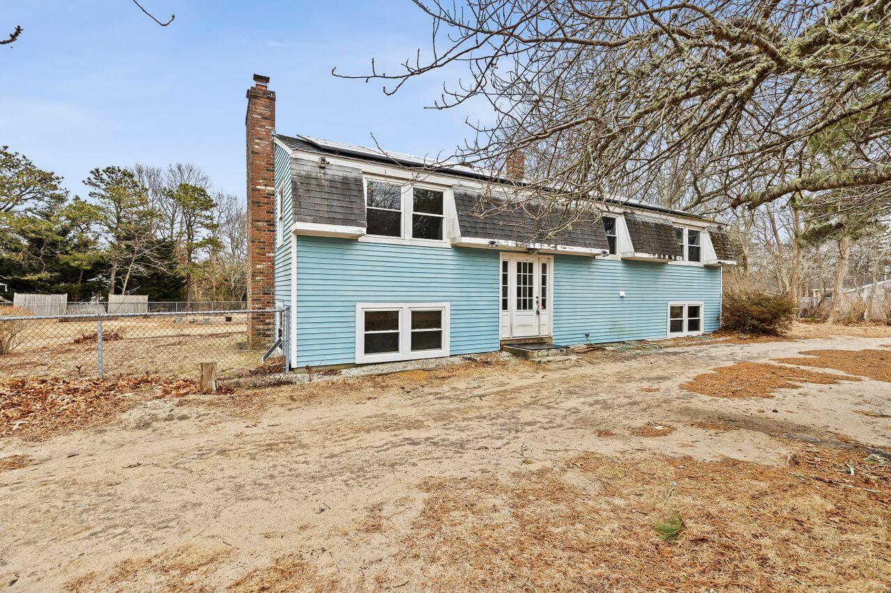 1460 Massasoit Road Eastham, MA 02642 - Photo 35 of 42 a front view of a house with a yard