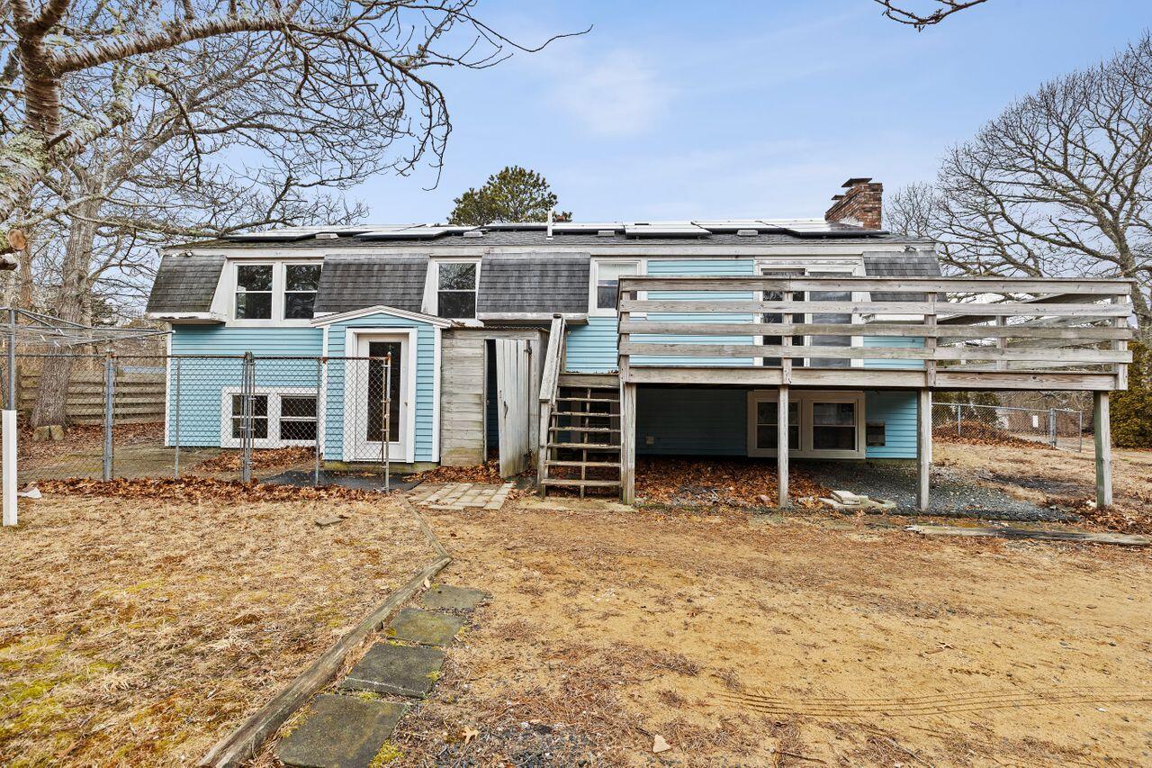1460 Massasoit Road Eastham, MA 02642 - Photo 36 of 42 a view of a house with a backyard