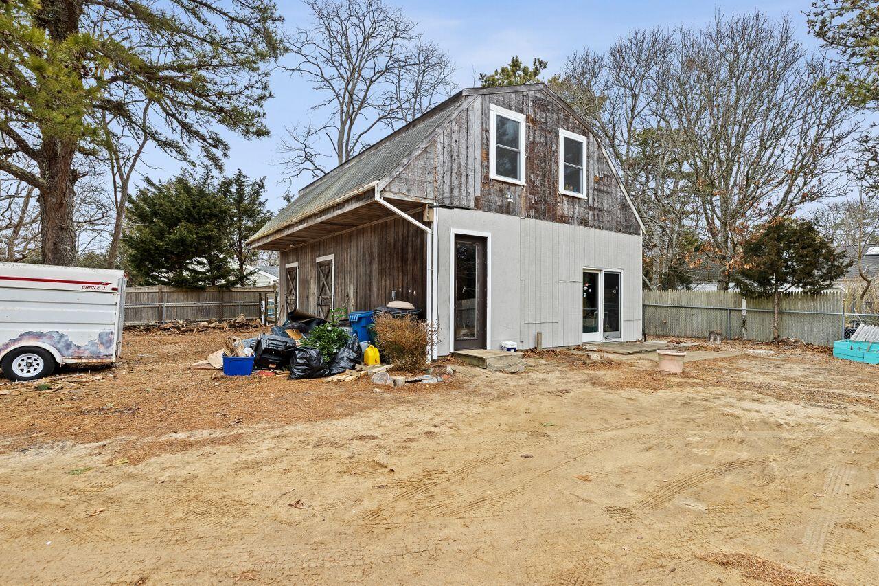 1460 Massasoit Road Eastham, MA 02642 - Photo 42 of 42 a view of a house with a yard covered in snow