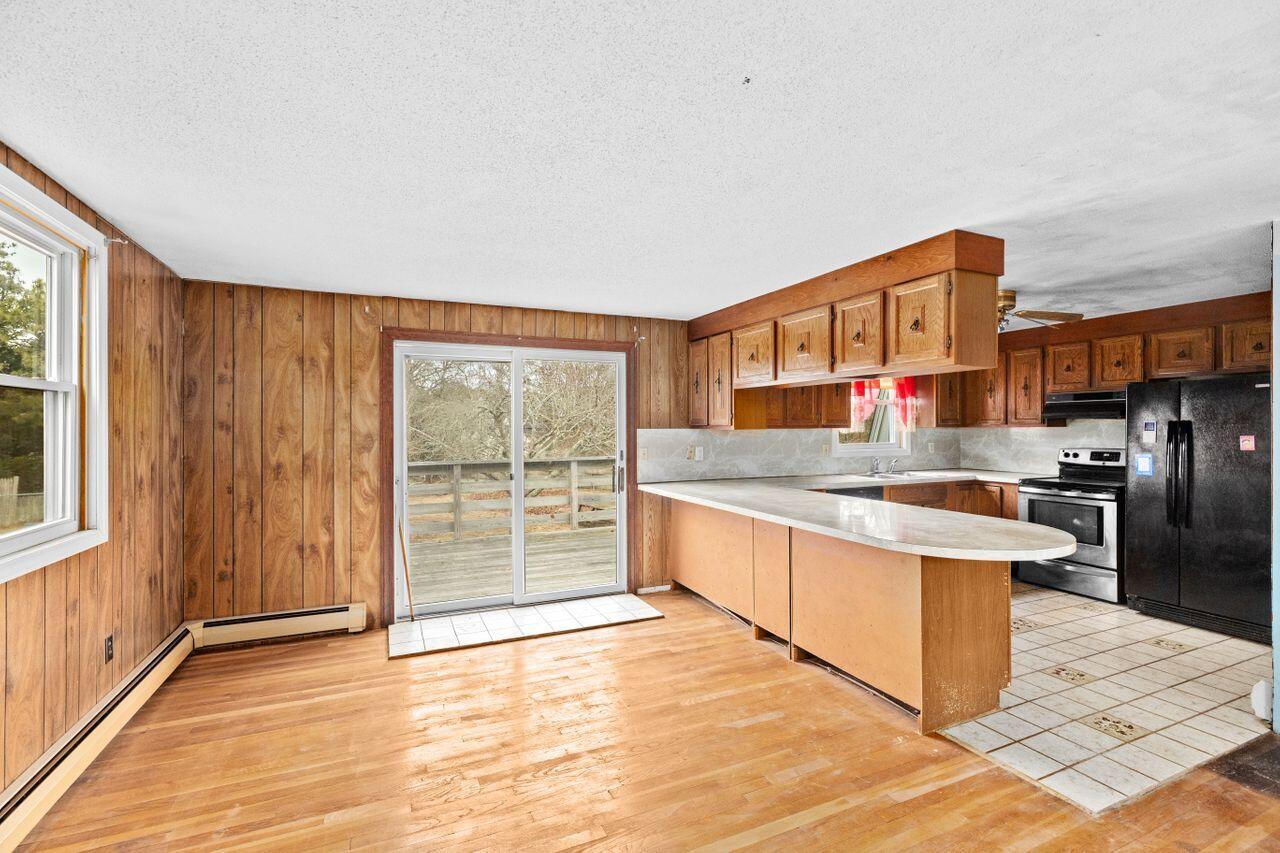 1460 Massasoit Road Eastham, MA 02642 - Photo 6 of 42 a kitchen with stainless steel appliances granite countertop a stove a sink and a refrigerator