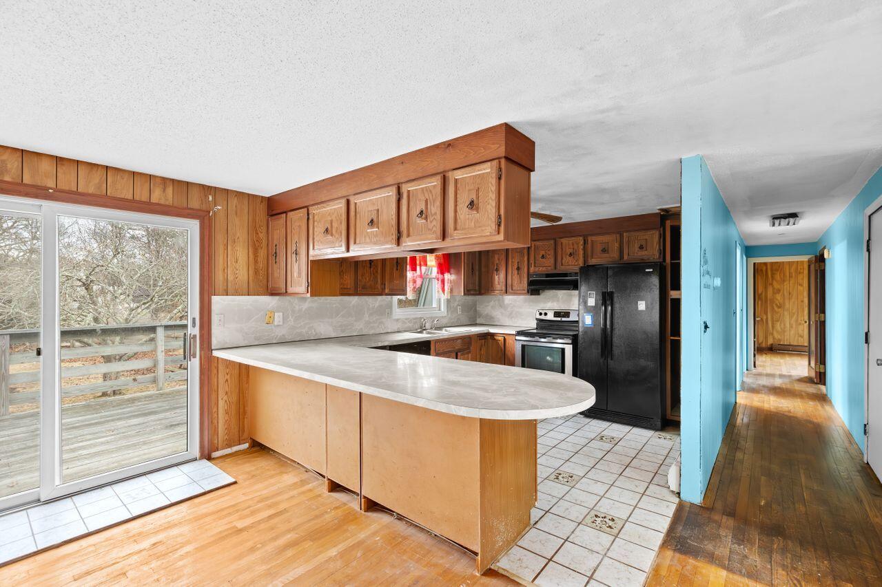 1460 Massasoit Road Eastham, MA 02642 - Photo 7 of 42 a large kitchen with stainless steel appliances granite countertop a stove a sink and a refrigerator
