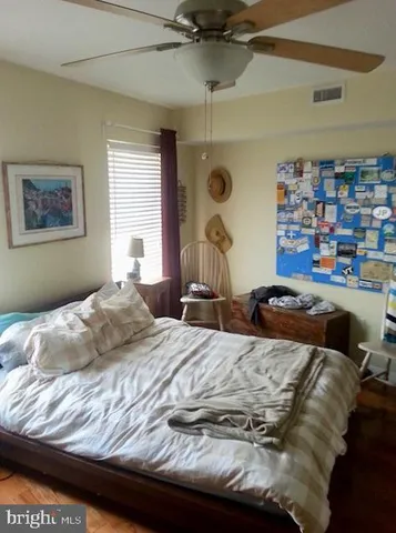 a bedroom with bed and a window