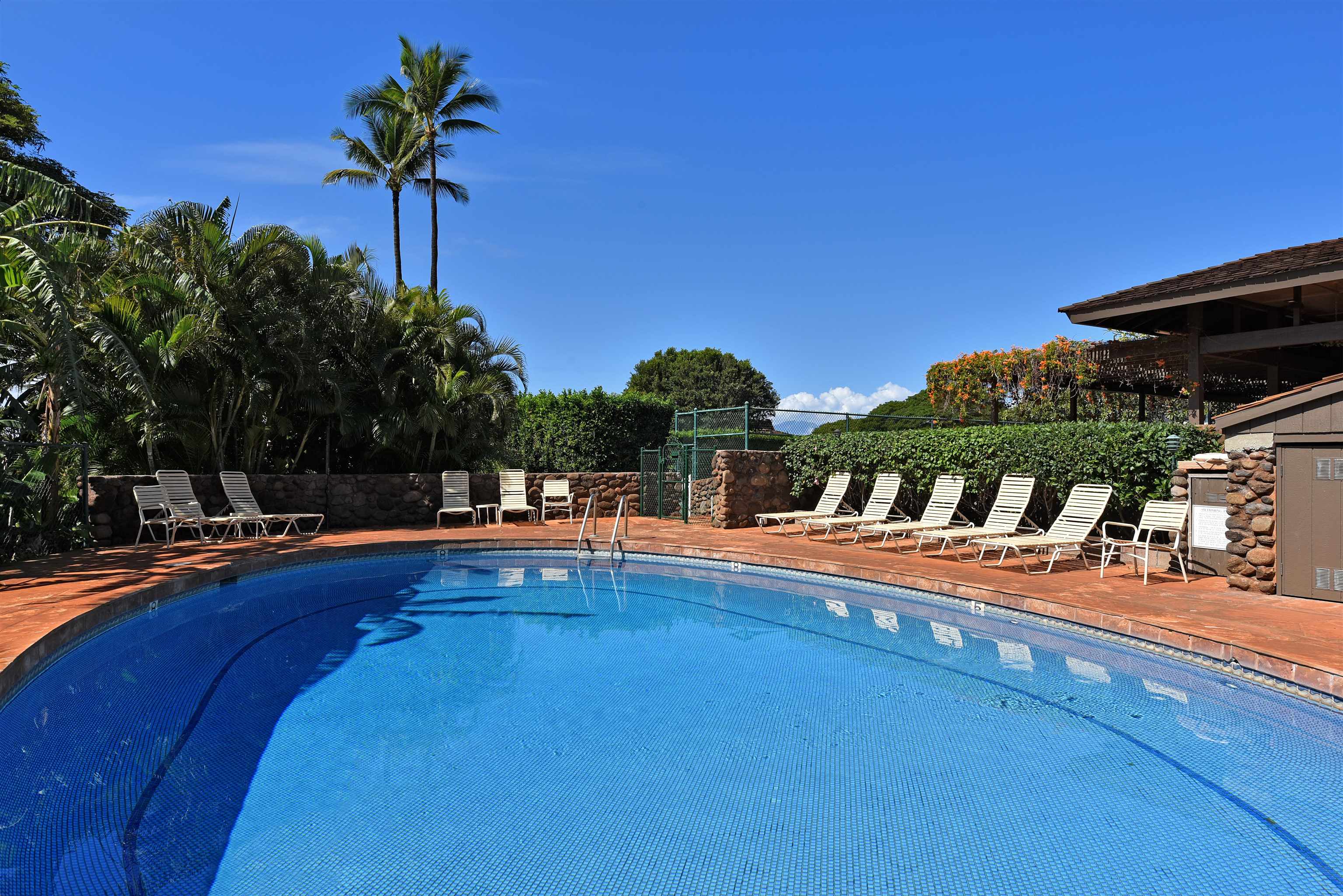 150 Puukolii Road, Unit 52 Lahaina, HI 96761 - Photo 43 of 50 a view of a swimming pool with a table and chairs
