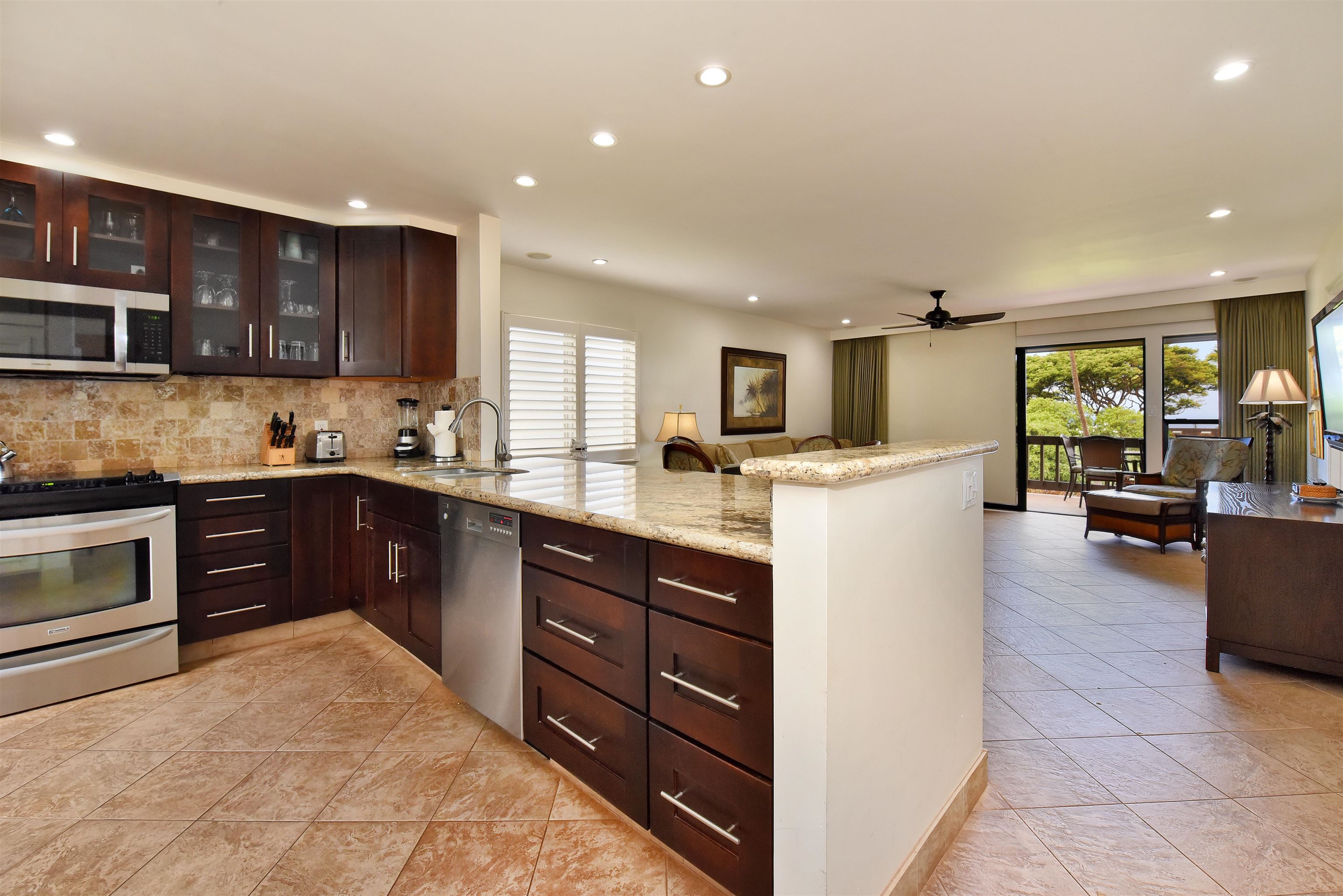 150 Puukolii Road, Unit 52 Lahaina, HI 96761 - Photo 6 of 50 a kitchen with stainless steel appliances granite countertop a refrigerator stove microwave and sink