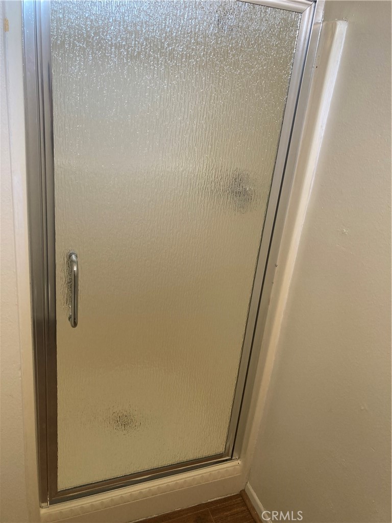 13237 Mohawk Road Apple Valley, CA 92308 - Photo 11 of 21 a bathroom with a glass shower door