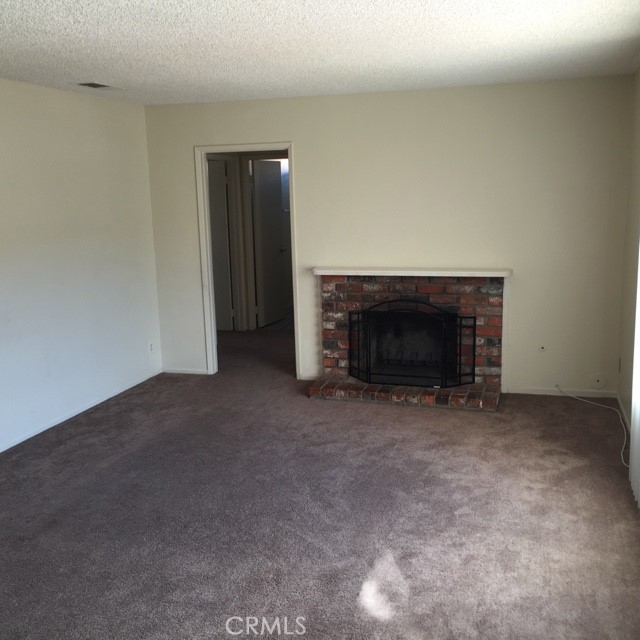 13237 Mohawk Road Apple Valley, CA 92308 - Photo 5 of 21 a view of empty room with a fireplace