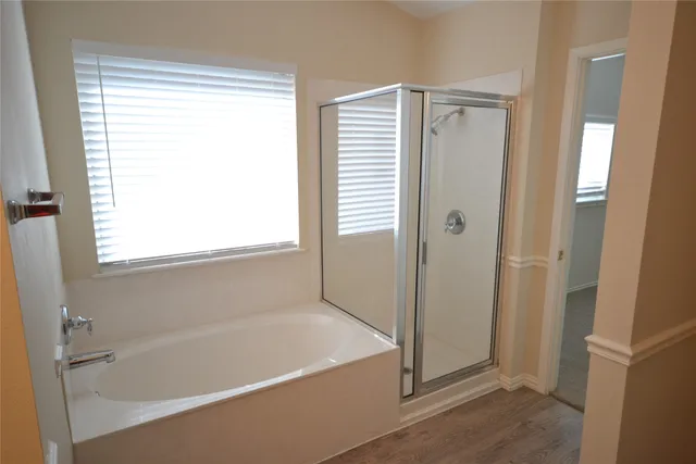 a white bath tub sitting next to a shower