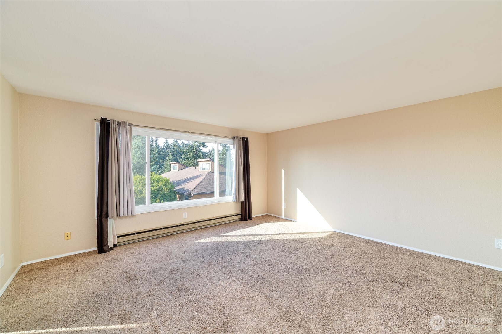 221 Southwest 154th Street, Unit 8 Burien, WA 98166 - Photo 2 of 10 an empty room with large windows