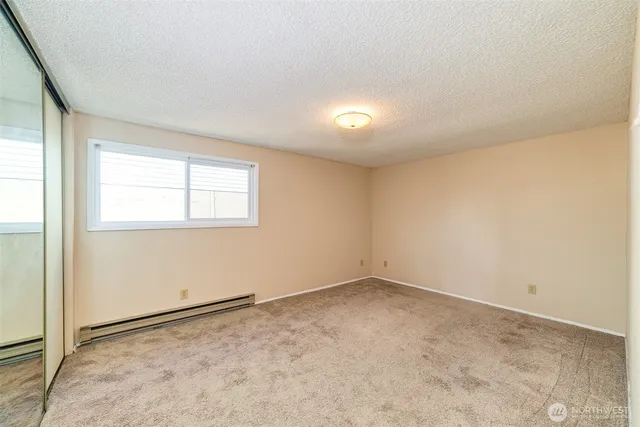 an empty room with a empty space and windows