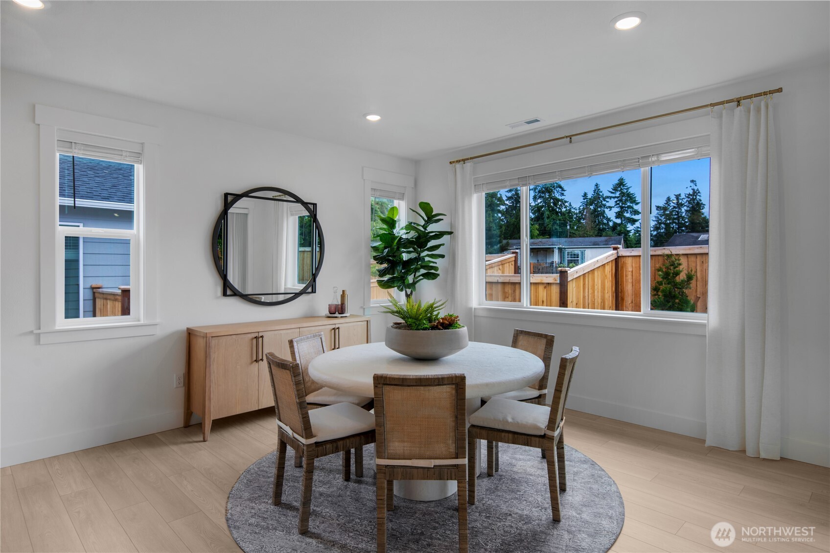 616 Sunbeam Place Sequim, WA 98382 - Photo 7 of 26 a dining room with furniture a potted plant and a window