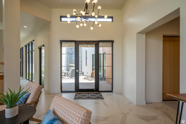 3606 South Cypress Road Hurricane, UT 84737 - Photo 25 of 69 Foyer entrance featuring hanging lights, light marble finish floors, and a high ceiling