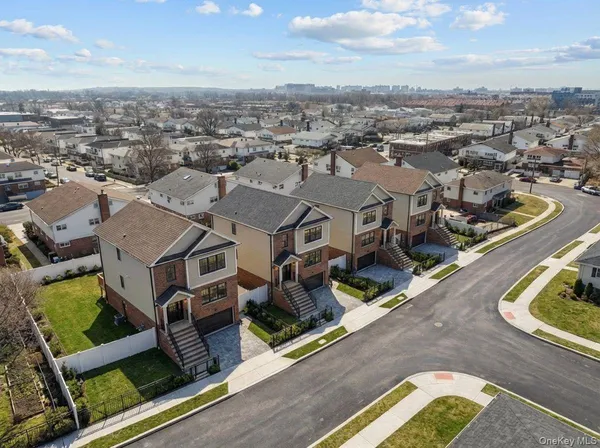 an aerial view of residential houses with yard