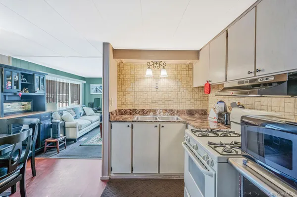 a kitchen with a stove a sink and a refrigerator