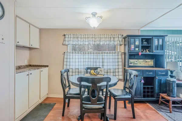 a dining room with furniture and window
