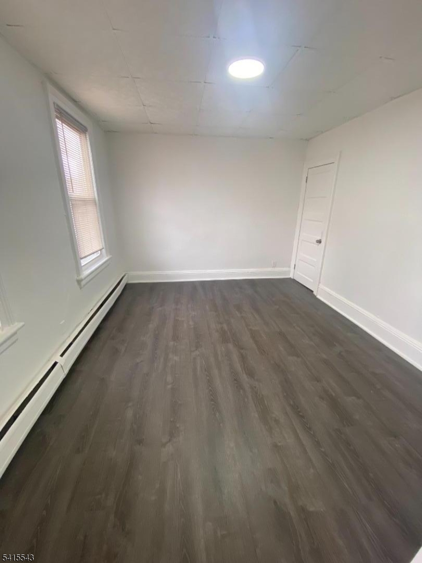 61 Highland Street Paterson, NJ 07524 - Photo 1 of 13 an empty room with wooden floor and windows