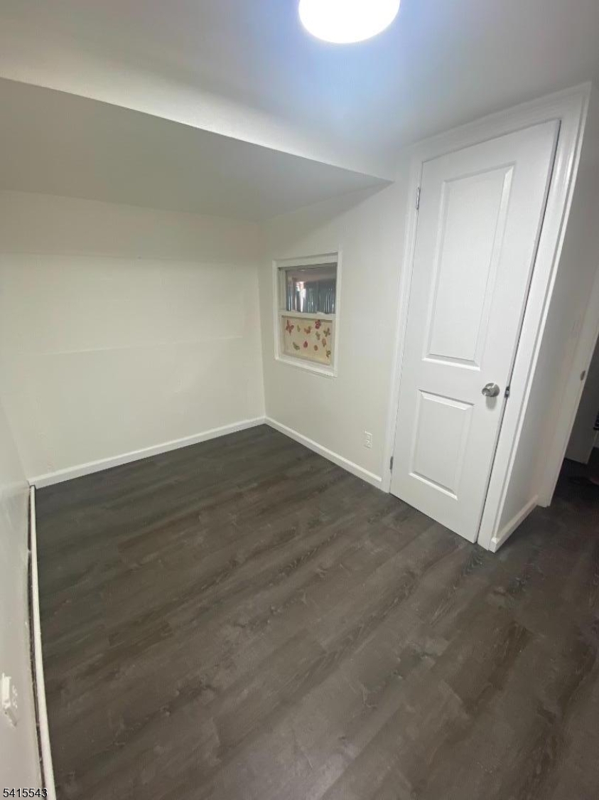 61 Highland Street Paterson, NJ 07524 - Photo 4 of 13 an empty room with a bench