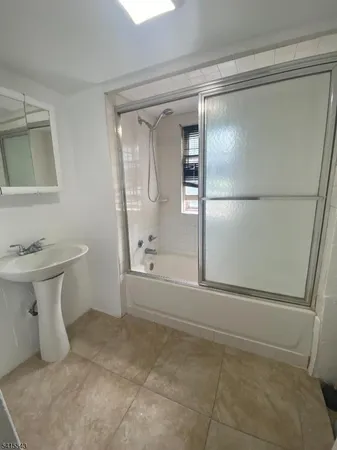 a bathroom with a shower and mirror