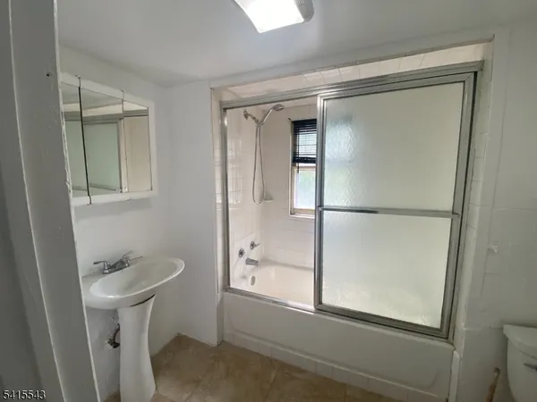 a bathroom with a shower and mirror