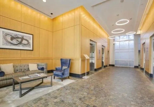 a living room with furniture and a dining table